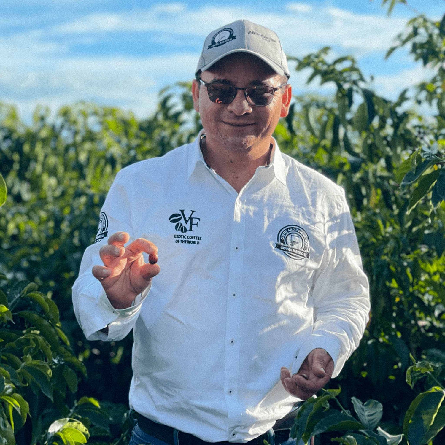 Coffee Producer Wilton Benitez on a coffee farm with a cherry in his hand